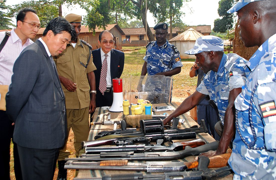 North Korean vice Minister of the the Ministry of Peoples Security, Mr. Ri Song Chol (second from the left) inspects weapons at a police training academy in Kampala, Uganda, in June 2013. 