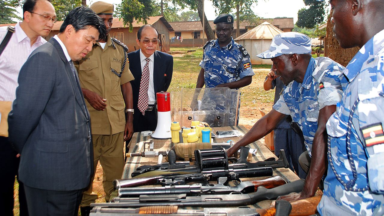 North Korean vice Minister of the the Ministry of Peoples Security, Mr. Ri Song Chol (second from the left) inspects weapons at a police training academy in Kampala, Uganda, in June 2013.