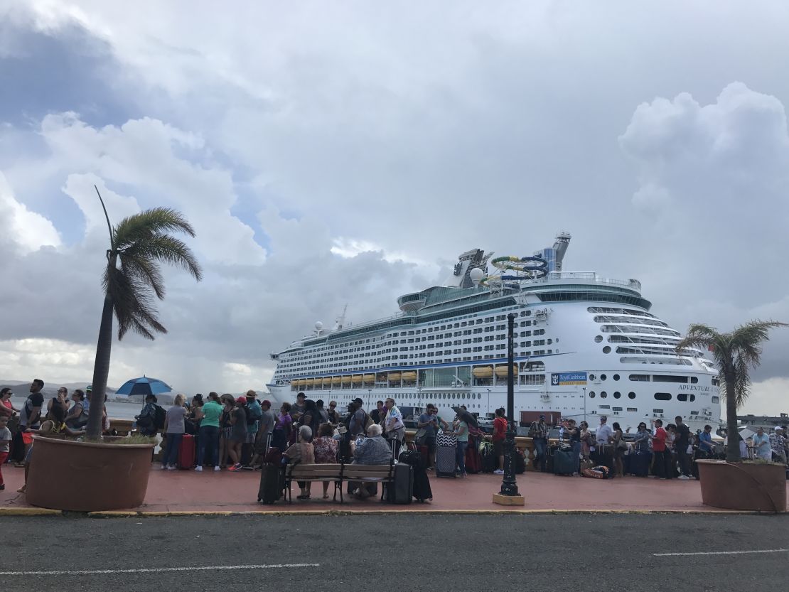 Puerto Ricans line up to try and board a cruise ship to leave the island.