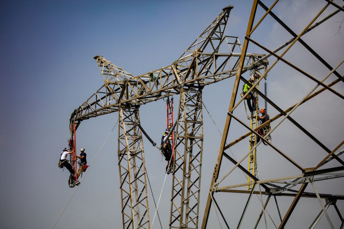 Linemen work to restore a key central transmission route.