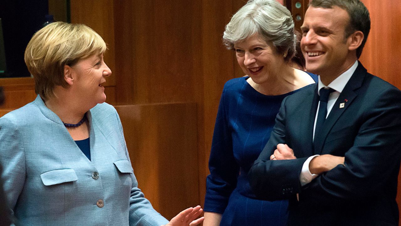 German Chancellor Angela Merkel, UK Prime Minister Theresa May and French President Emmanuel Macron talk in Brussels, Belgium, on October 19 during a summit of EU leaders.