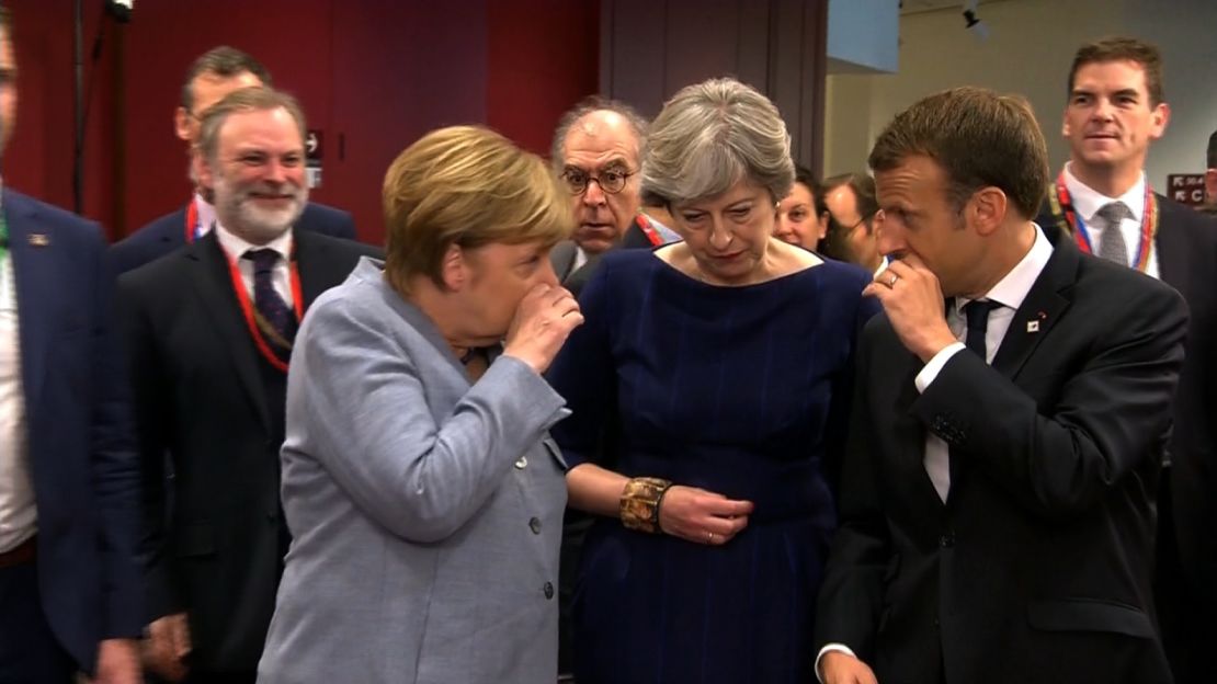 Merkel and Macron whisper to May at the European Council summit.