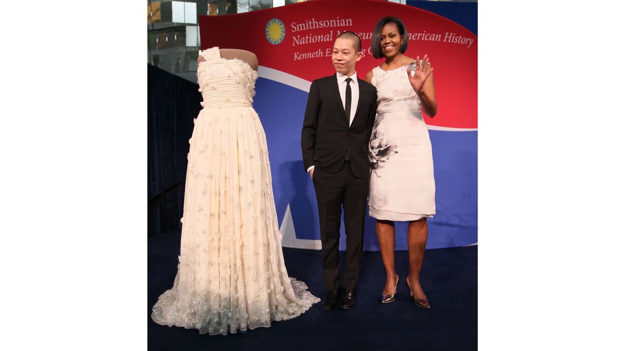 First lady Michelle Obama and inaugural dress designer Jason Wu look at her inaugural gown that's now on display at the Smithsonian museum on March 9, 2010.