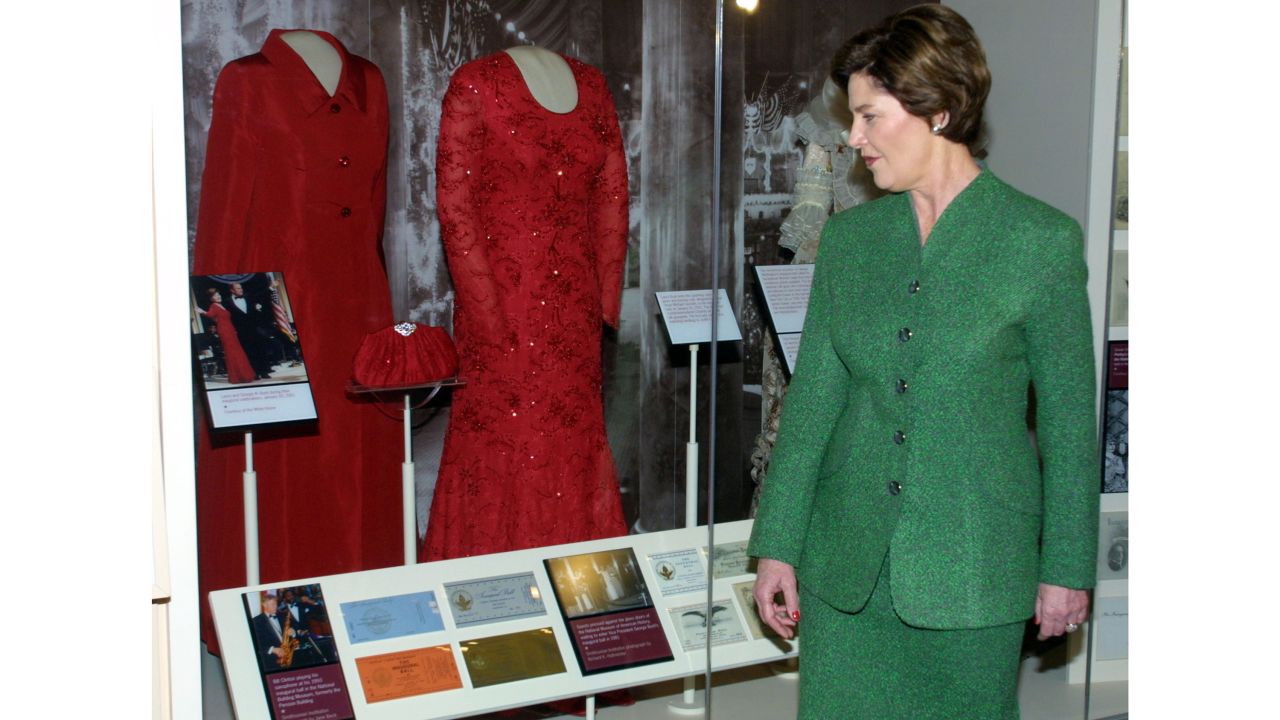 First lady Laura Bush looks at her inaugural ball gown after it was set on display at the American history museum on January 20, 2002.