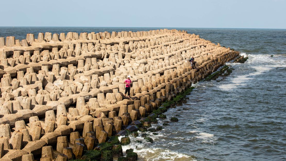 A fisherman tries his luck casting into the sea from a breakwater on Egypt's rapidly changing coast.