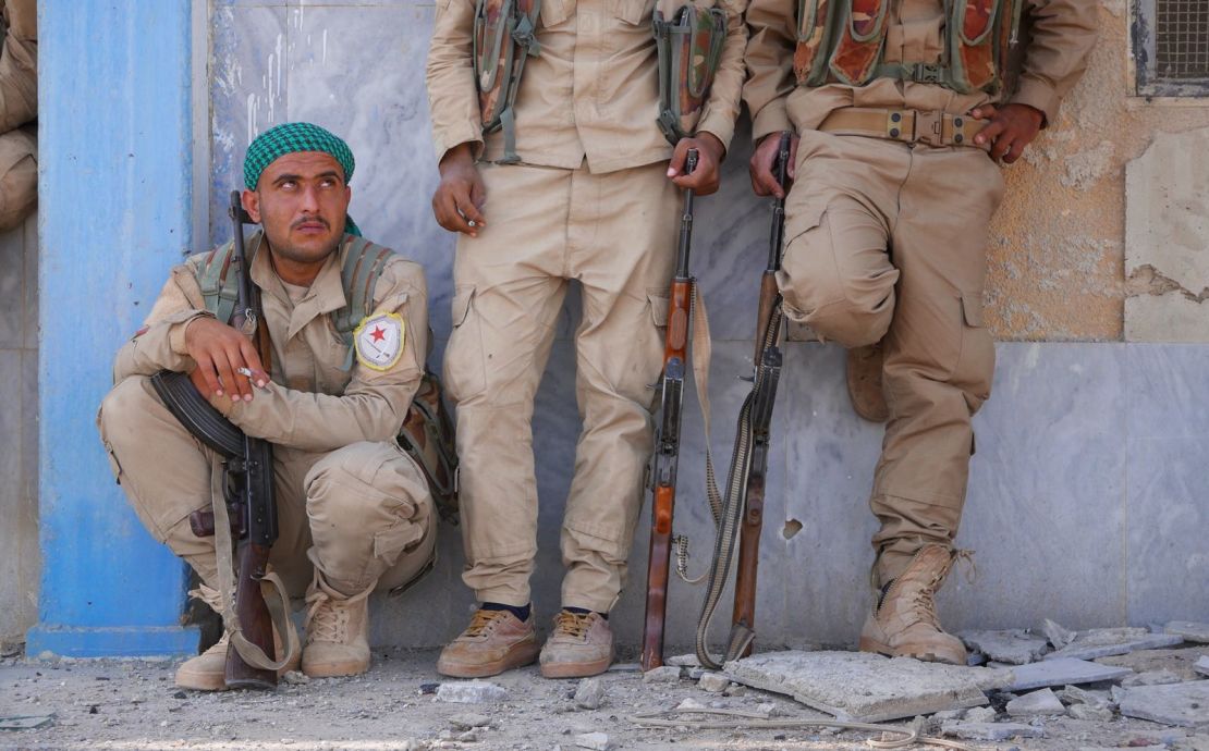 SDF fighters gather at the stadium in central Raqqa ahead of a ceremony to celebrate the capture of Raqqa. 