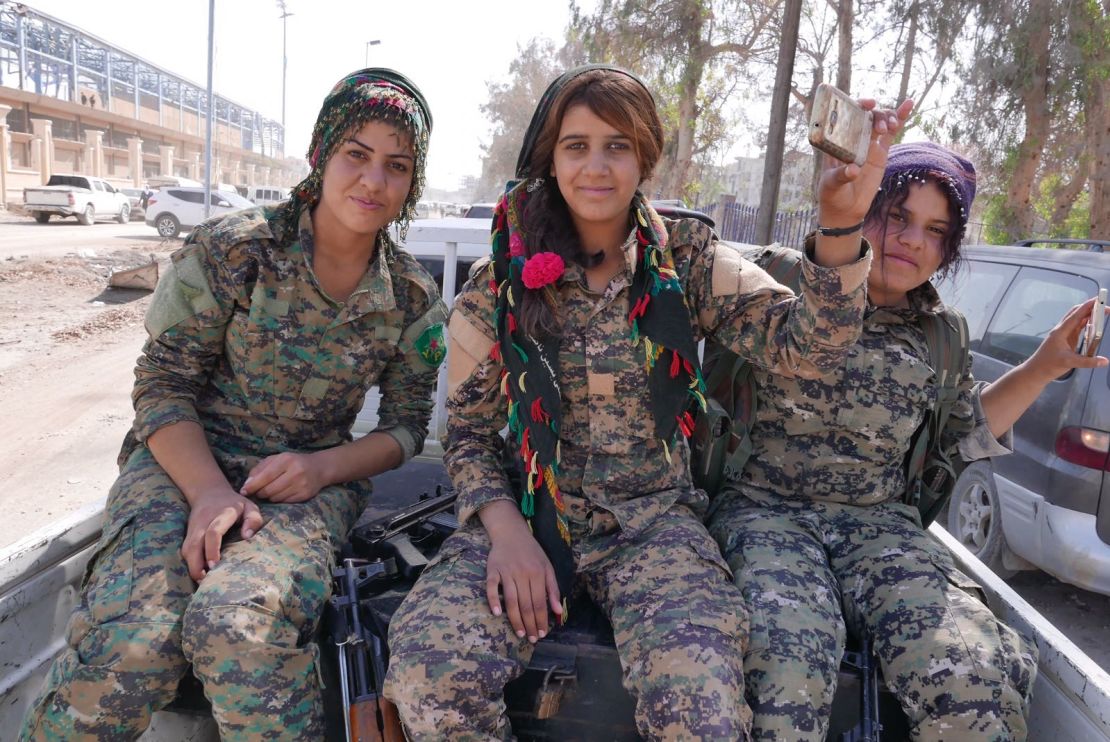Female Kurdish fighters head towards Raqqa stadium for celebrations after the defeat of ISIS.