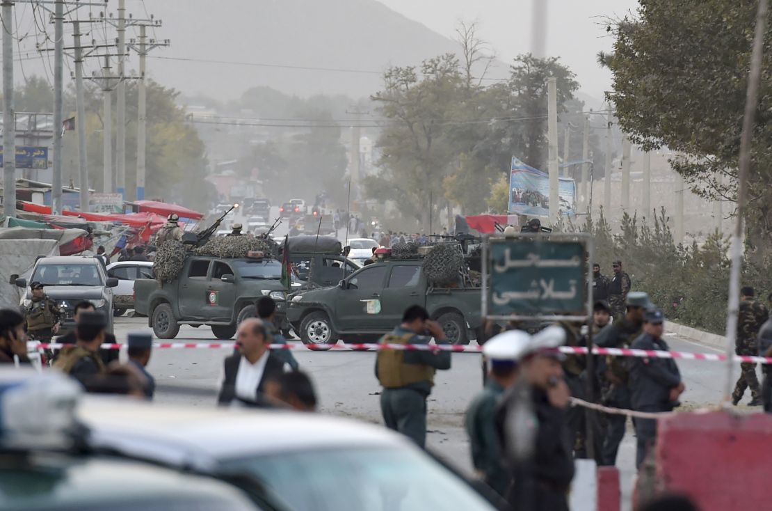 Security personnel gather Saturday near the site of the suicide bomb attack in the Afghan capital.