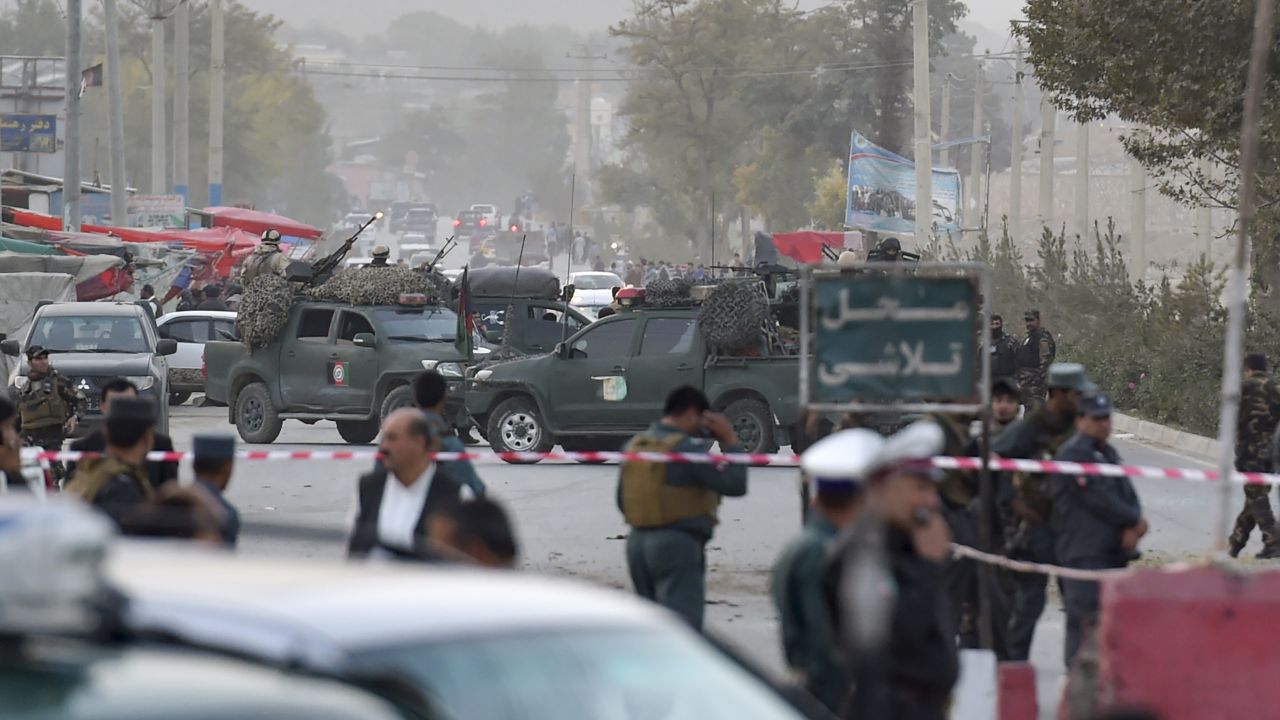 Security personnel gather Saturday near the site of the suicide bomb attack in the Afghan capital.