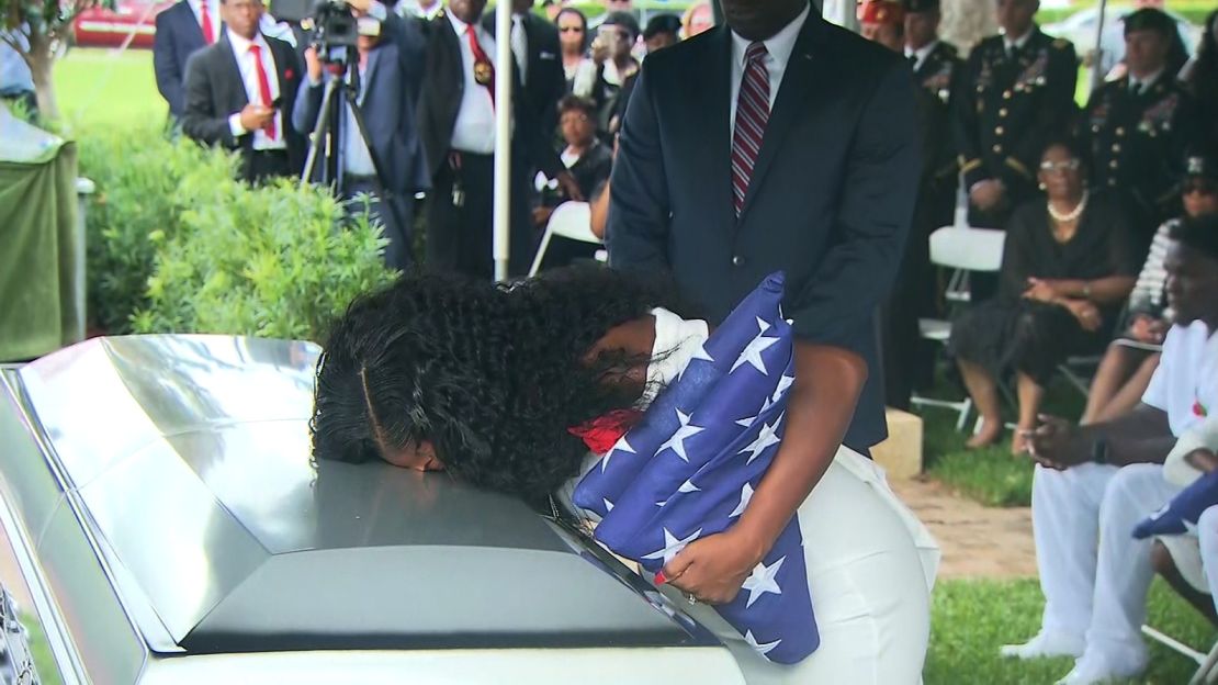 Sgt. La David Johnson's widow, Myeshia, kisses his casket before his burial Saturday.