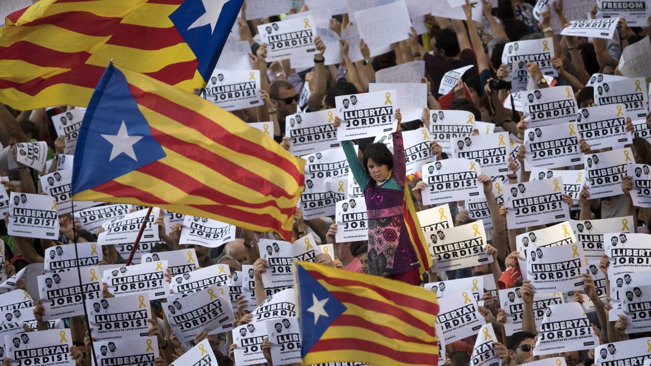 Protesters hold signs reading "Freedom for the two Jordis" on Saturday, referring to two jailed Catalan activists.