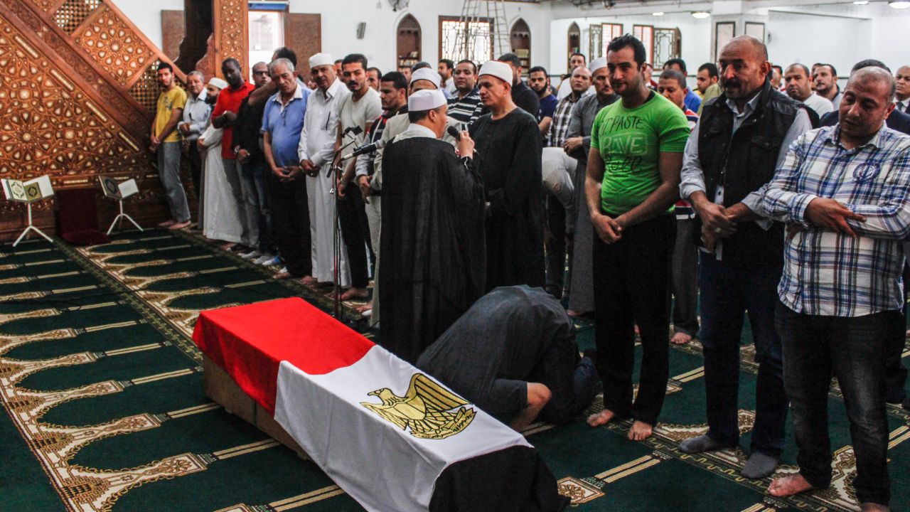 Mourners in Cairo pray during a funeral Saturday for a police captain killed in the desert shootout.