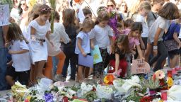 Children place cards and flowers at an informal memorial site as thousands gather during a national rally to demand justice for murdered Maltese journalist and anti-corruption blogger Daphne Caruana Galizia in the island's capital Valletta on October 22, 2017.
Galizia, 53, a prominent Maltese journalist and blogger who made repeated and detailed corruption allegations against Prime Minister Joseph Muscat's inner circle, was killed by a car bomb on October 16, 2017. / AFP PHOTO / Matthew Mirabelli / Malta OUT        (Photo credit should read MATTHEW MIRABELLI/AFP/Getty Images)