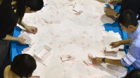 Japanese election officials in Tokyo count ballot papers for the vote on Sunday.