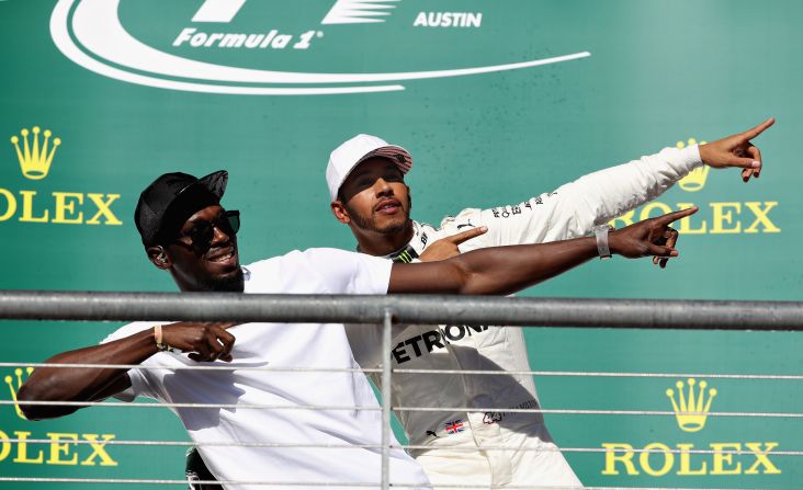 Lewis Hamilton and Usain Bolt in familiar pose on the podium at the US Grand Prix in Austin. 