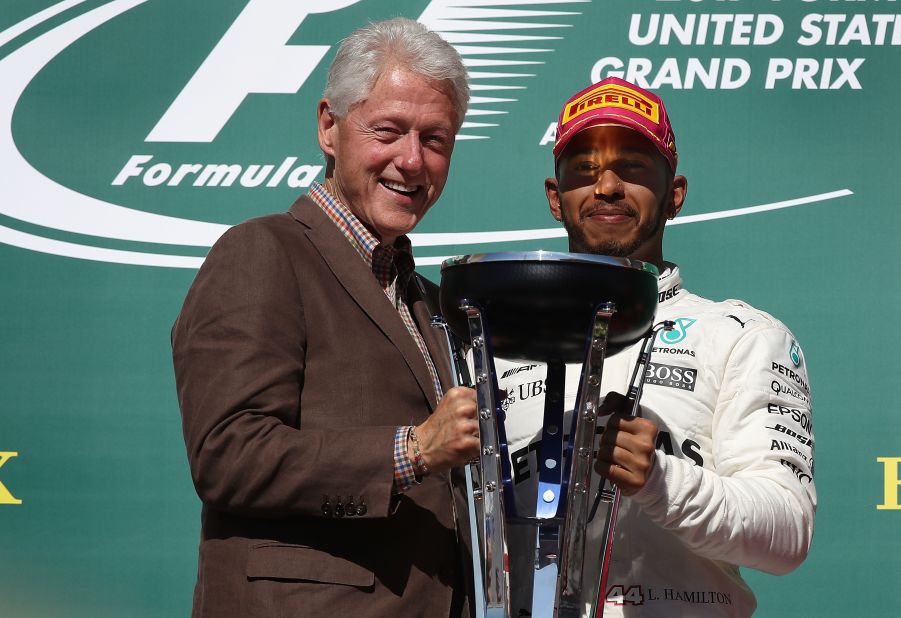 Former US President Bill Clinton presented Hamilton with his winner's trophy at the Circuit of the Americas. 