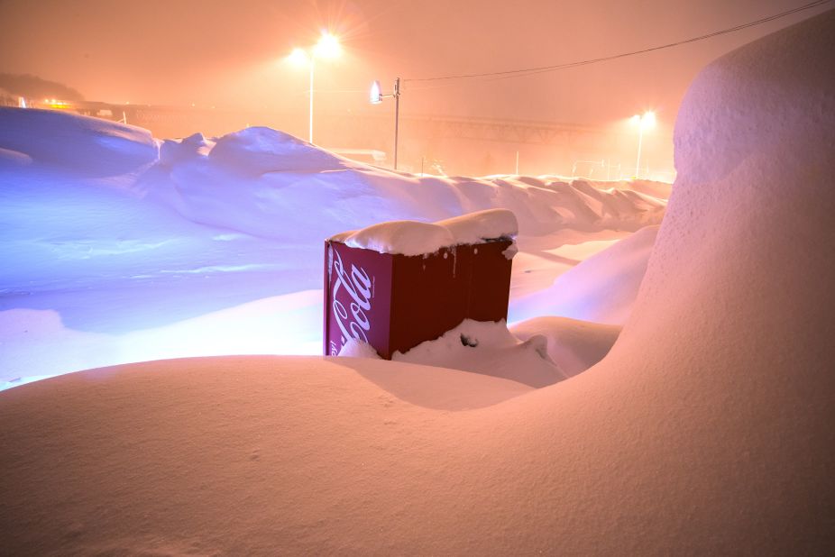 Otaru is a port city northwest of Sapporo, and a popular tourist destination: "The machine is working while buried in the snow at the roadside of the national highway."