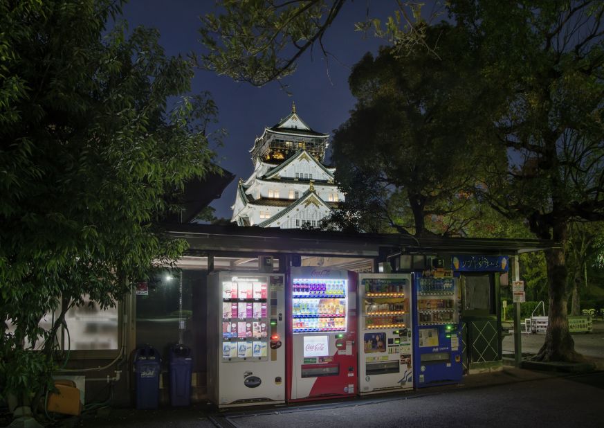 Vending machines with Osaka Castle in the background.