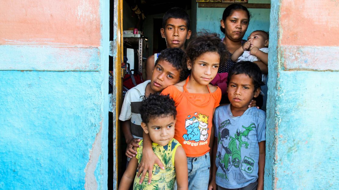 Patrícia Santos da Silva and her six children. She is holding baby Gabriel, who has what she calls the "tiny mosquito problem."