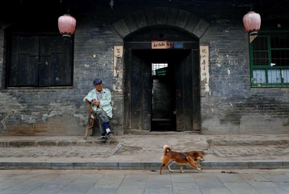 An old man rests outside his traditional-style home in Pingyao ancient city. 