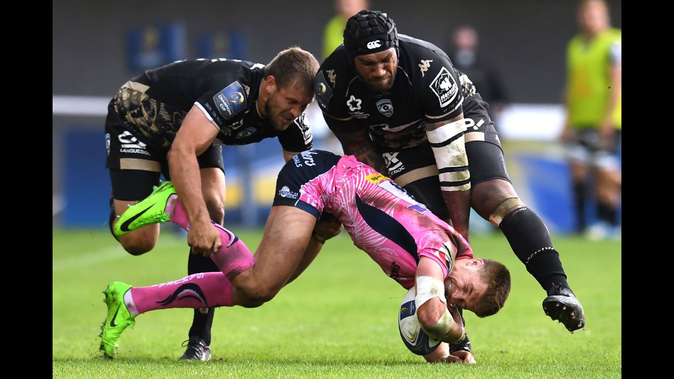 Exeter's Henry Slade is tackled by Montpellier's Francois Steyn, left, and Nemani Nadolo during a Champions Cup rugby match in Montpellier, France, on Sunday, October 22.