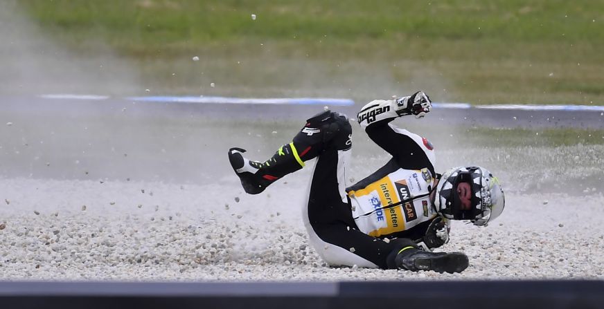 Iker Lecuona slides through gravel Saturday, October 21, after falling from his motorcycle during a practice session for the Moto2 race in Australia. He raced the next day and finished in 20th place.