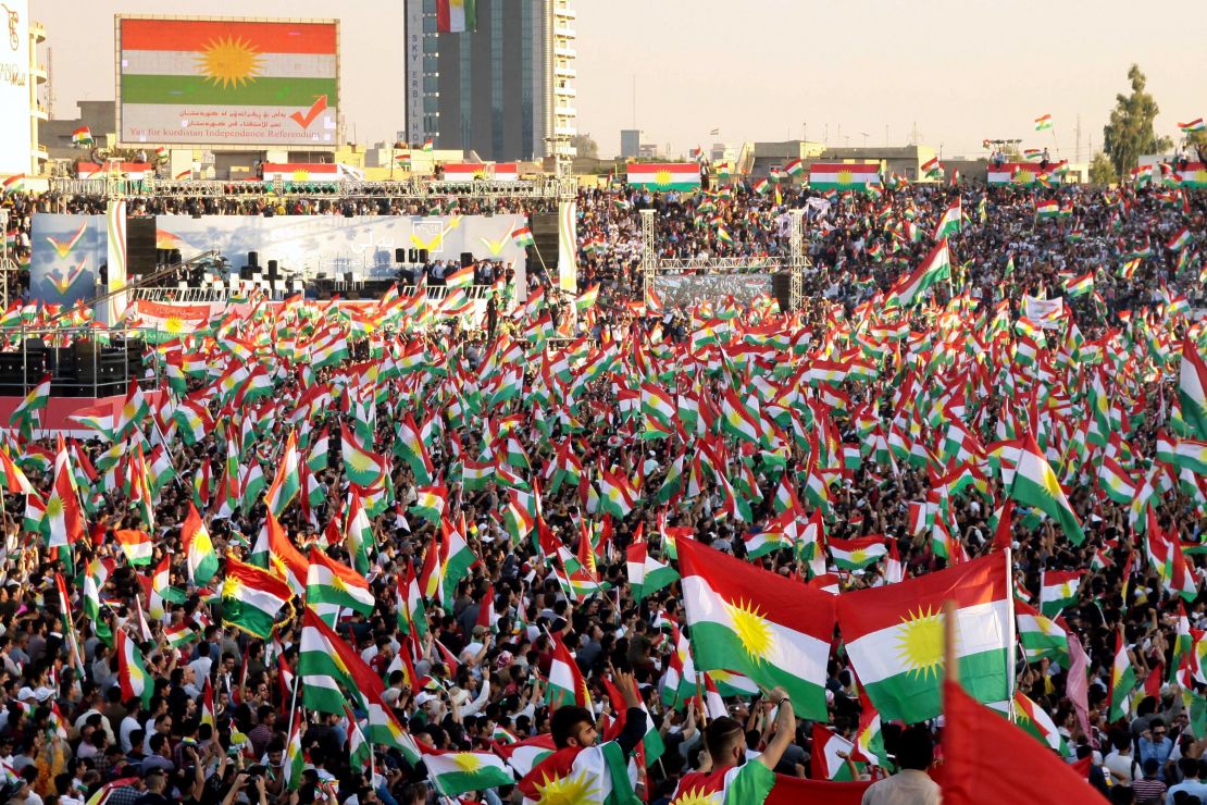Iraqi Kurds fly Kurdish flags during an event to urge people to vote in the independence referendum in Arbil.