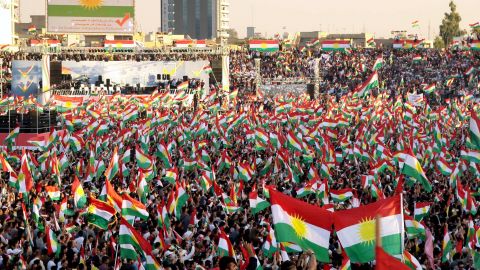 Iraqi Kurds fly Kurdish flags during an event to urge people to vote in the independence referendum in Arbil.