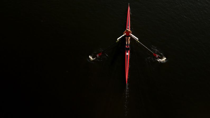 A rower makes her way to the starting line before the Head of the Charles Regatta in Boston on Saturday, October 21.