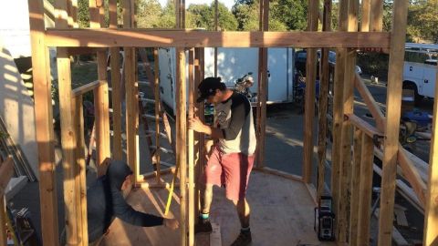 A man at work on a tiny house.