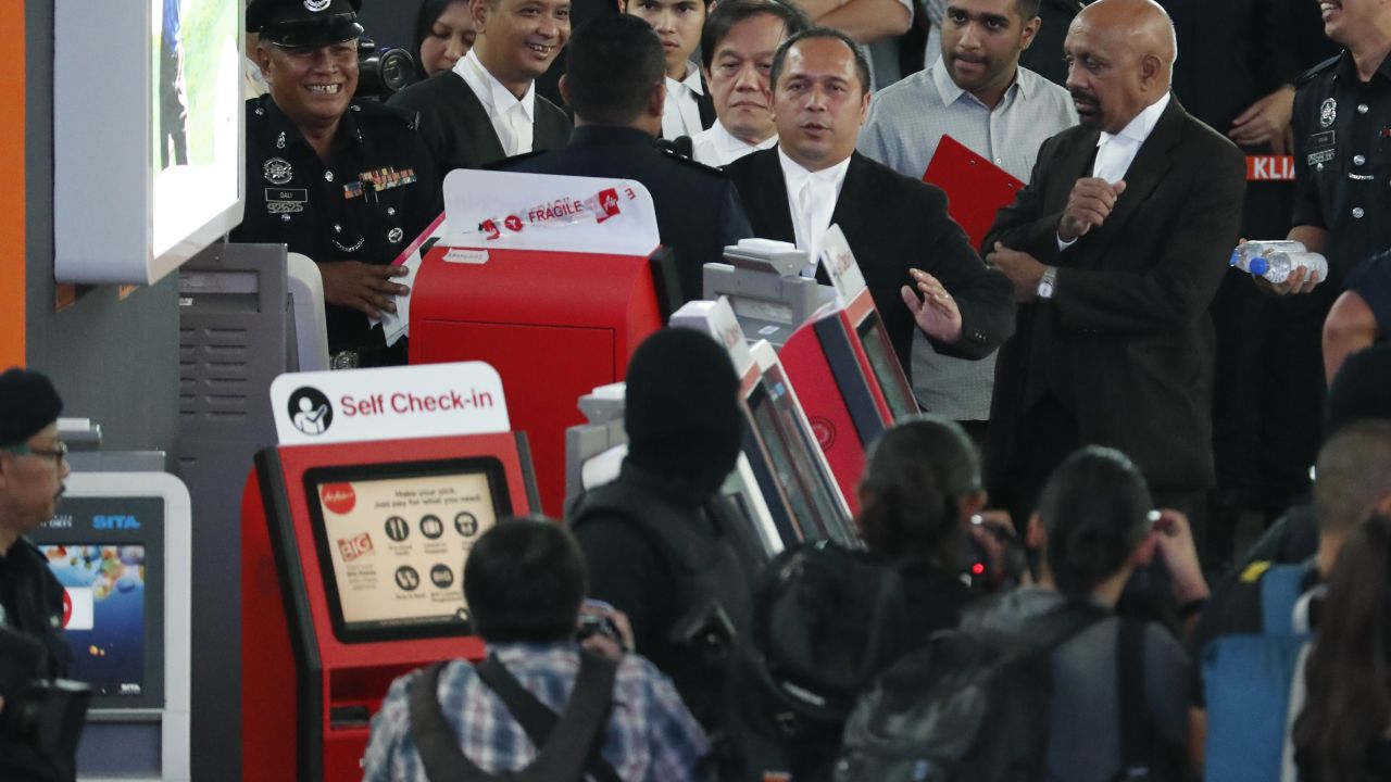 Malaysian deputy public prosecutor Muhammad Iskandar Ahmad, center, visits the check-in kiosk at KLIA2 where the attack on Kim is understood to have taken place.