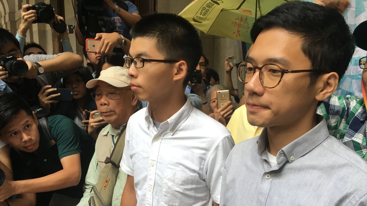 Joshua Wong and Nathan Law speak to the media after their release on bail by a Hong Kong court on October 24, 2017.