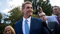 Sen. Jeff Flake (R-AZ) and his wife Cheryl Flake leave the U.S. Capitol as they are trailed by reporters, October 24, 2017 in Washington, DC.