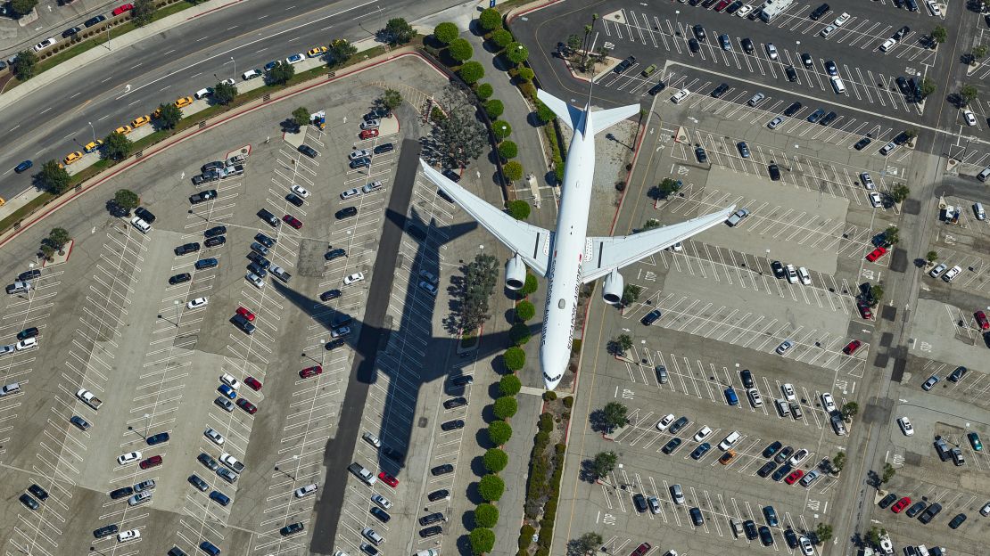 Prensena took this image of a plane at LAX Airport by hanging out of a helicopter. 