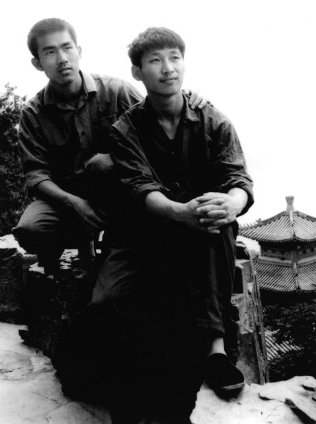 Xi, right, poses for a photo as a college student in 1977.