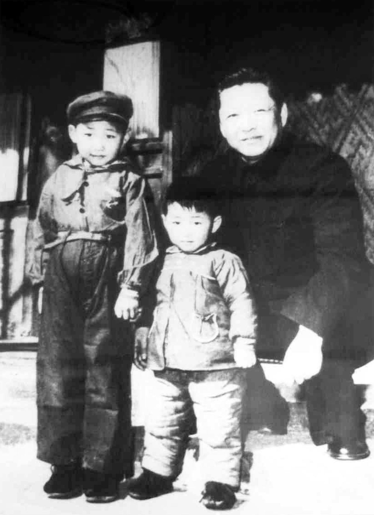 XI, left, stands with his father, Xi Zhongxun, and his younger brother, Xi Yuanping, in 1958. Xi Zhongxun was a communist revolutionary who held several positions in the National People's Congress.
