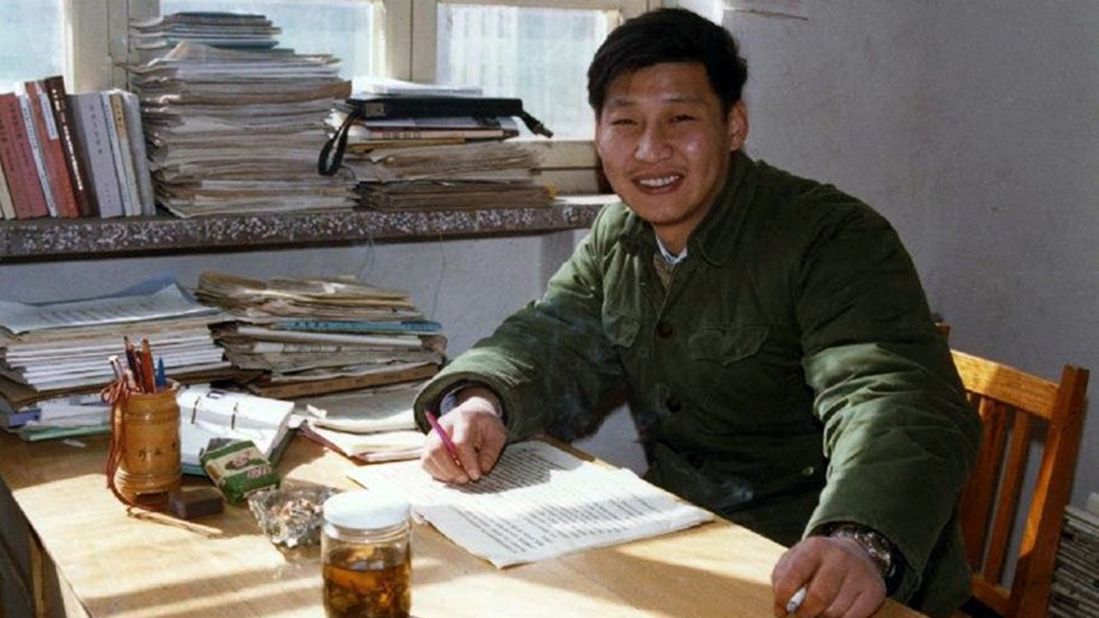 Xi poses for a photo as he sits in his office in 1983.