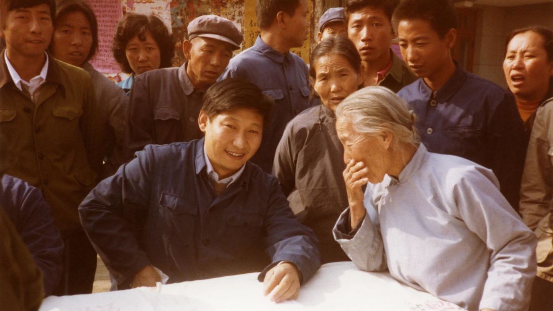 Xi listens to villagers in north China's Zhengding County in 1983. At the time, he was secretary of the Zhengding County Committee.