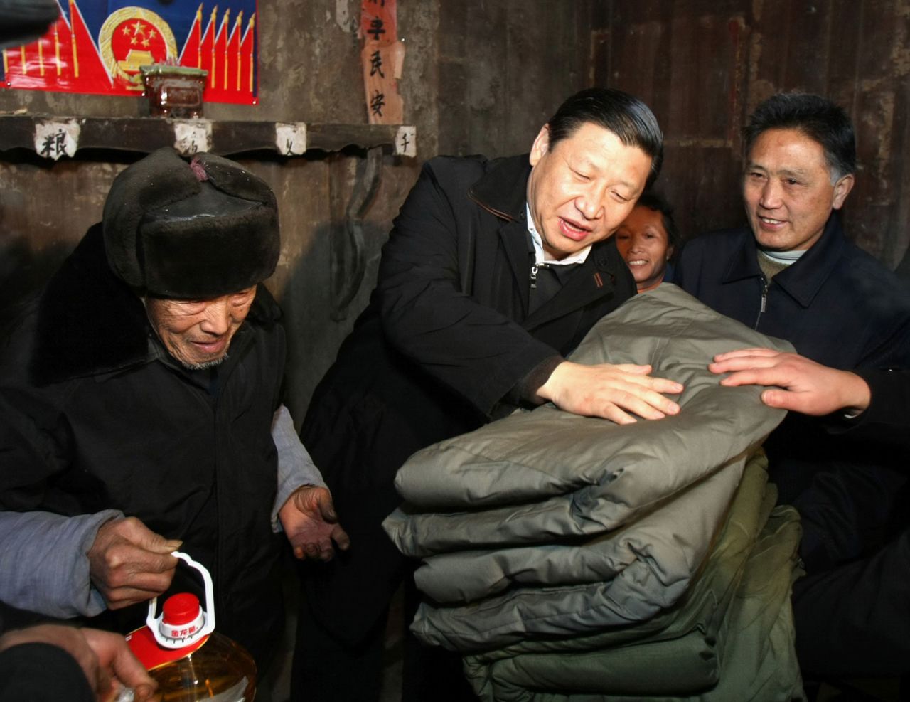 Xi brings blankets to a villager after ice storms in 2008. That year, Xi became China's vice president.