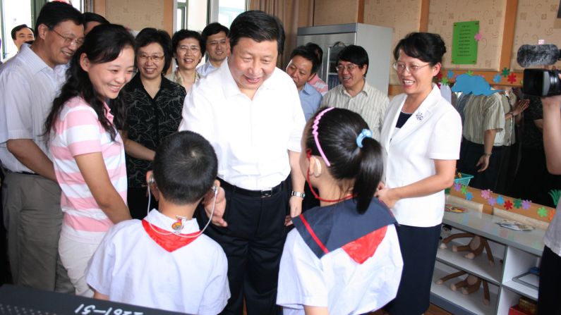 Xi talks with hearing-impaired students at a school in Shanghai in 2007.