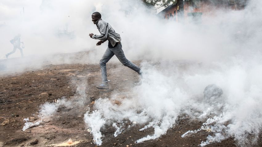 NAIROBI, KENYA - OCTOBER 26: A National Super Alliance (NASA) protestor runs from a tear gas canister in the Kibera slum on October 26, 2017 in Nairobi, Kenya. Protestors have Kibera boycotted the vote and are attempting to block polls during Kenya's controversial rerun election.  (Photo by Andrew Renneisen/Getty Images)
