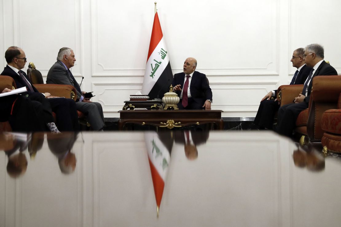 Abadi (C) met with US Secretary of State Rex Tillerson (2nd L) in Baghdad on Monday. 