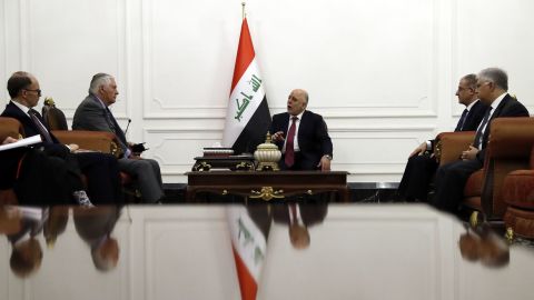 Abadi (C) met with US Secretary of State Rex Tillerson (2nd L) in Baghdad on Monday.