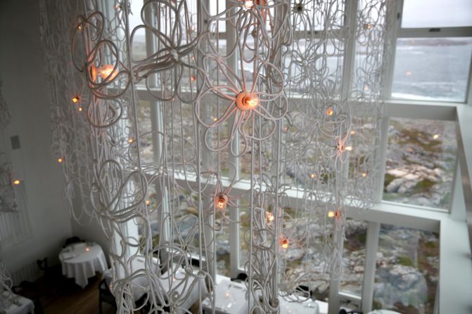 The dining room, which looks out over the ocean, features chandeliers by Dutch designer Frank Tjepkema.