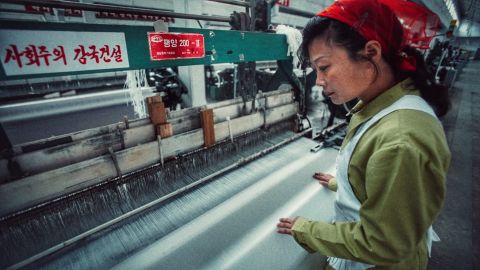 Mun Gang Sun operates a loom inside the Kim Jong Suk textile mill.