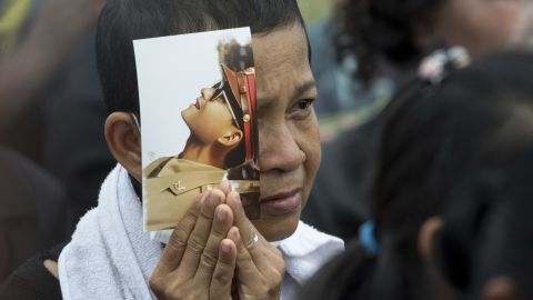 A mourner holds a portrait of King Bhumibol Adulyadej during his funeral procession and royal cremation ceremony in Bangkok. 