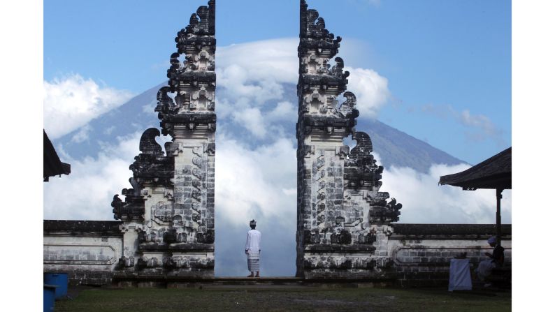 <strong>Karangasem, Bali:</strong> A man keeps an eye on the active and threatening Mount Agung volcano.