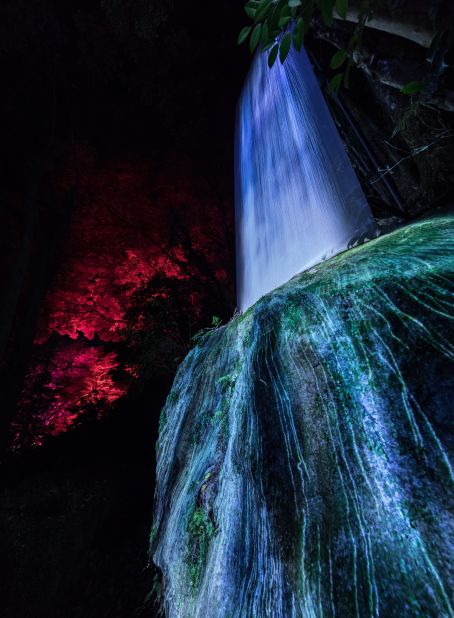 A spectacular, digital waterfall cascades down the rock.