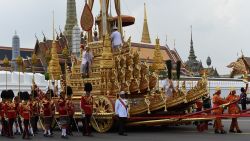 The Royal Urn is carried in the Royal Chariot during the funeral procession for the late Thai king Bhumibol Adulyadej in Bangkok on October 26, 2017.
A sea of black-clad mourners massed across Bangkok's historic heart early on October 26 as funeral rituals began for King Bhumibol Adulyadej, a revered monarch whose passing after a seven-decade reign has left Thailand bereft of its only unifying figure.  / AFP PHOTO / Anthony WALLACE        (Photo credit should read ANTHONY WALLACE/AFP/Getty Images)
