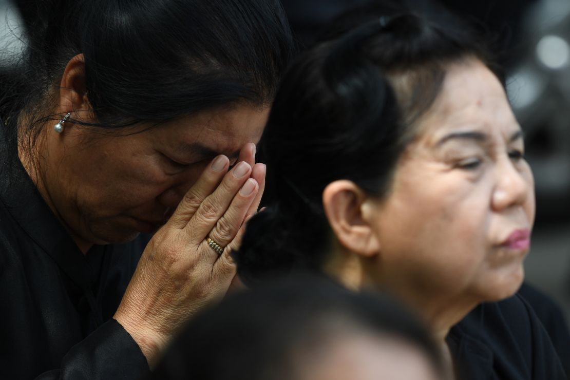 Mourners react during the funeral.